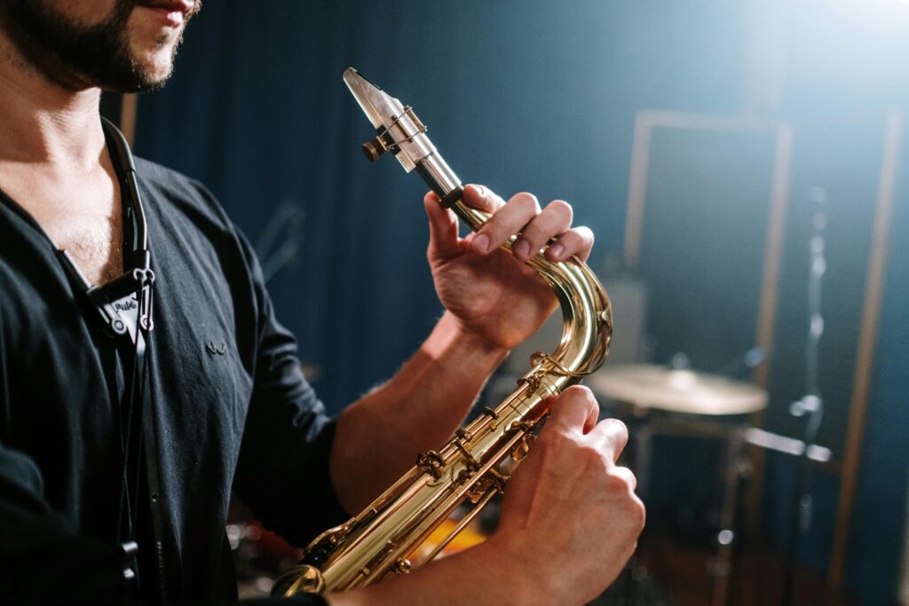 A musician plays a saxophone in a studio, capturing the essence of live music.