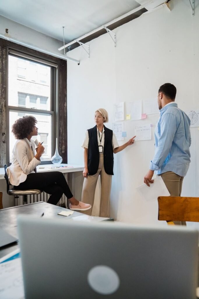 Professionals discussing project plans during a team meeting in a contemporary office.